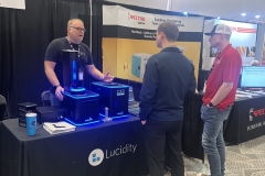 Dan-I-at-booth-with-customers-rotated