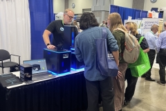 Iversen-in-booth-w-visitors